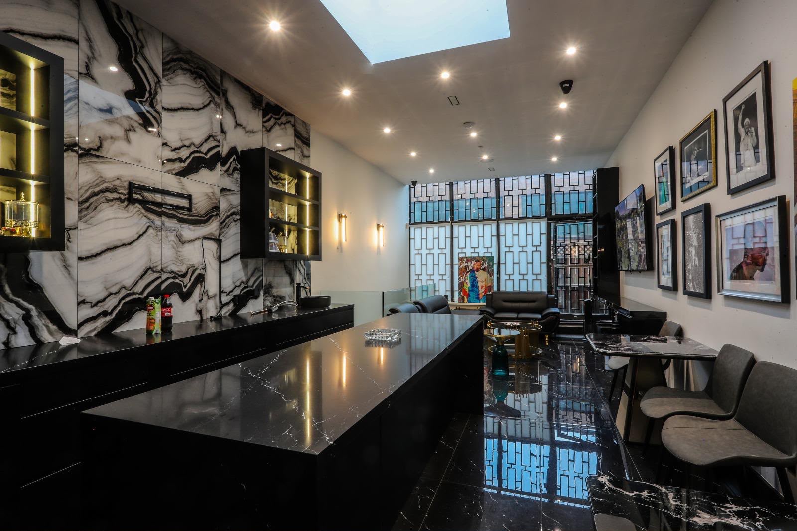 Marble bar and lounge seating beside the tall patterned window wall